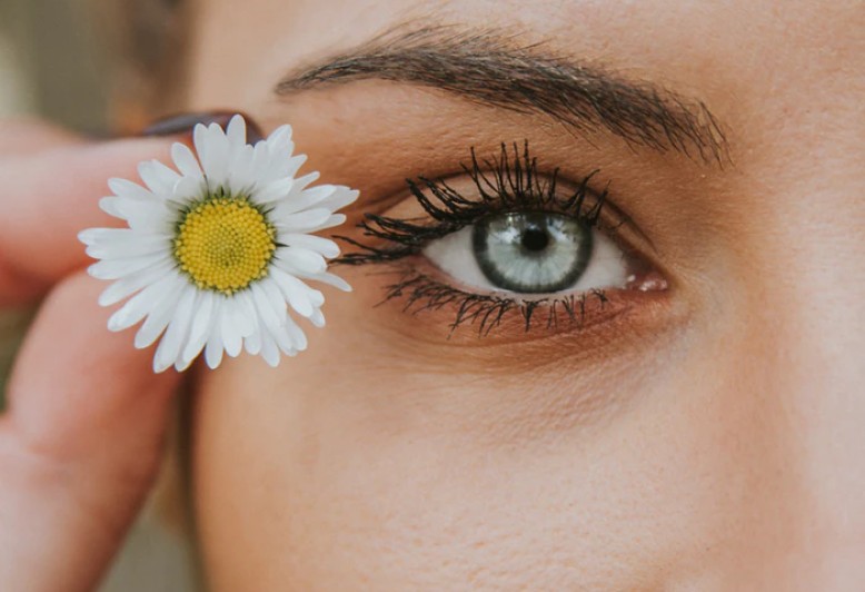 Picture of a beautiful woman's eyes and small white flower