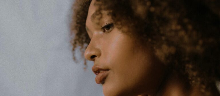 zoomed photo of a woman with curly hair