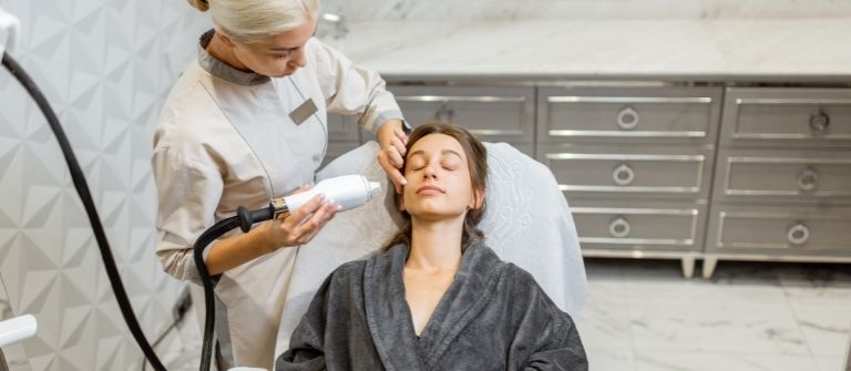 Dermatologist Giving a Woman a exilist elite Treatment