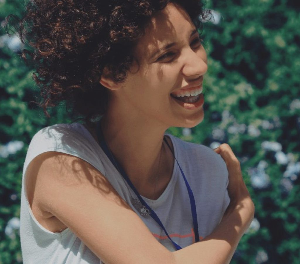 woman with curly hair laughing